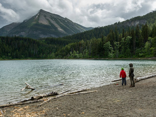 Tourists at lakeshore, Crandell Lake, Waterton Lakes National Park, Alberta, Canada