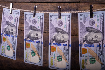 Money Laundering. Money Laundering US dollars hung out to dry. 100 dollar bills hanging on...