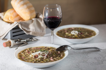 Rustic bean and farro soup with pancetta, onion, rosemary and celery. Italian food.