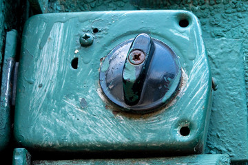 Old aged lock in blue paint splatters on metal rustic background of gate or door. Security or vintage things concept