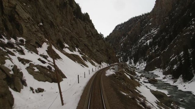 Train tracks moving through snowy mountain pass