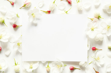 Naklejka na ściany i meble Creative layout of summer fresh flowers with space for text on white paper. Mockup. View from above. - Image