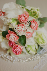Beautiful modern wedding bouquet on a white table. Wedding attributes. No people