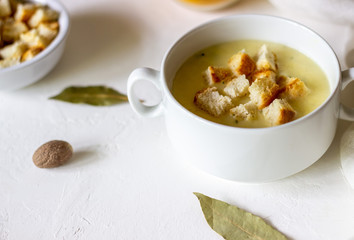 Cheese cream soup on a white background. White bread croutons. Ingredients.