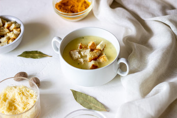 Cheese cream soup on a white background. White bread croutons. Ingredients.