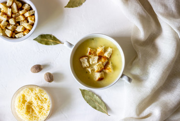 Cheese cream soup on a white background. White bread croutons. Ingredients.