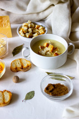 Cheese cream soup on a white background. White bread croutons. Ingredients.