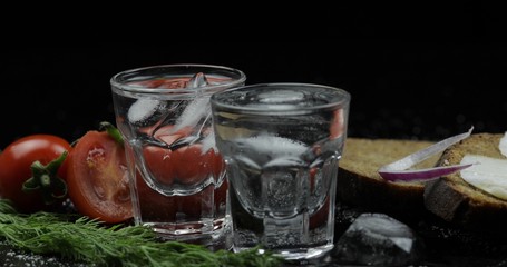 Alcohol drink vodka in shot glasses. Surface with snacks