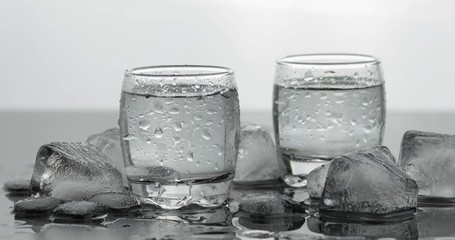 Shots of vodka in glasses. White background