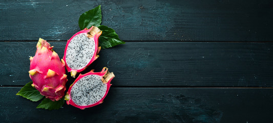 Fresh Pytahya on a black background. Dragon Fruit. Tropical Fruits. Top view. Free space for text.