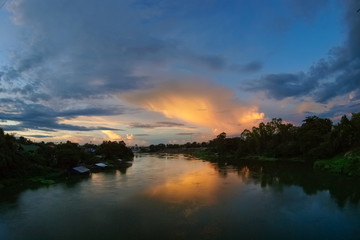 Naklejka na ściany i meble sunset at Mae Klong river, view of soft sun light above the river with cloudy sky background, Ban Pong District, Ratchaburi, Thailand.