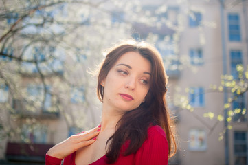 Obraz premium Portrait of stylish smiling happy brunette woman walking outdoors during sunny spring day while the sun is shining