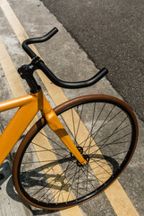Fototapeta na wymiar vintage yellow color bike park on road side