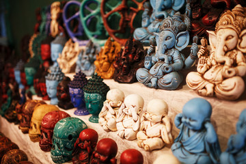 Indian gods souvenirs on the counter of the night market for tourists