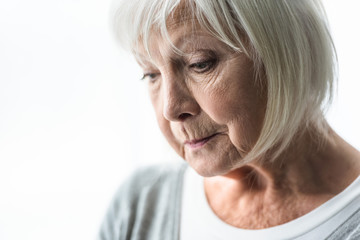 cropped view of pensive senior woman at home