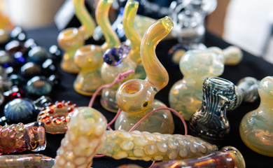 glass smoking pipes on a black background. Design accessories for smoking marijuana.