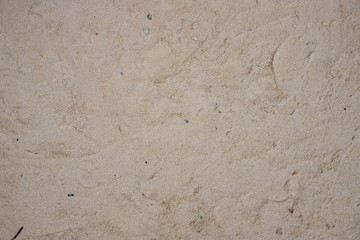 White yellow sand. Seashore sand beach texture with foot marks top view photo. Seaside natural backdrop