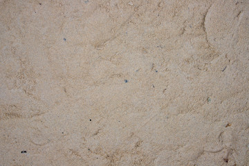 Yellow sand beach. Seashore sand beach texture. Ocean coast top view photo. Seaside natural backdrop