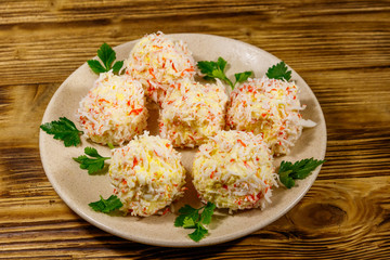 Appetizer of crab-cheese balls on wooden table