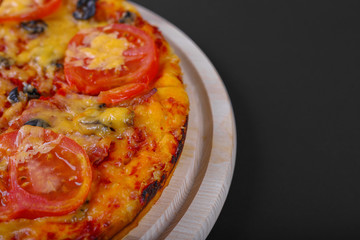 Close up of pizza on black background