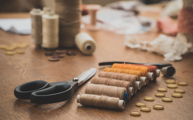Sewing concept. Scissors, threads and buttons.
