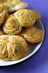 Pistachio roll buns served in a white plate with black rim. Violet linen napkin, high resolution