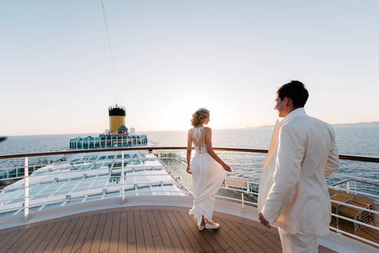 Young beautiful couple on the deck of a cruise liner in the sea