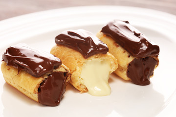 Traditional French dessert. Eclair with chocolate icing. Pastery concept with chocolate eclair