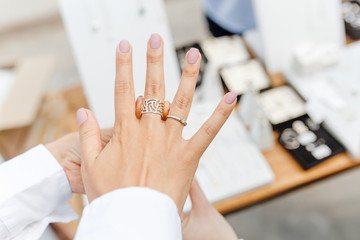 A woman trying on her new ring at outdoor flea handmade market, jewelry and shopping concept