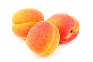 Three apricots isolated close-up.