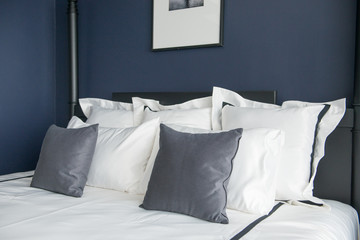 White comfortable pillow on bed decoration in hotel bed room interior