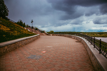 Fototapeta premium deserted city embankment on a cloudy summer day