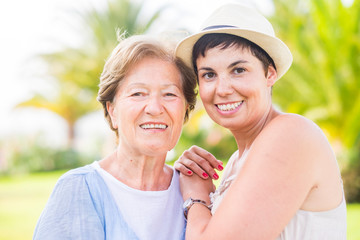 Portrait looking on camera for different ages people togehter - family concept with two women...