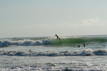 The surfer in the pipe. Waves on the island of Bali. The surfer catches the wave