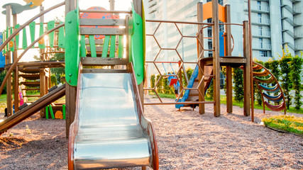 Fototapeta na wymiar Image of empty big wooden playground at park with lots old ladders, stairs and slides