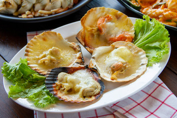 seafood - grilled scallop (hotate) with cheese lava and truffle sauce served in shell (halal food)