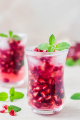 Mint pomegranate sparkling infused water. Selective focus, space for text.