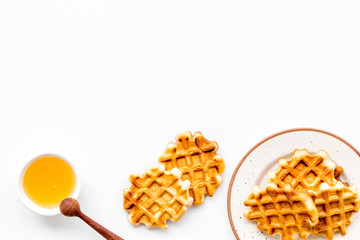 homemade Belgian waffles with honey on served table on white background top view space for text