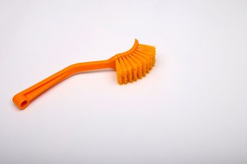 Massage brush on a white background. Orange massage brush. Cosmetics and accessories for bathrooms....