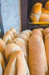 Fresh loaf of white bread. White bread on the showcase in the bakery. Hot baking. Bakery products made from wheat flour. Selective focus image, background, copy space.