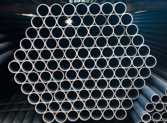 Metal steel and aluminium pipe heap in the cargo warehouse for transportation and logistics to the manufacturing factory