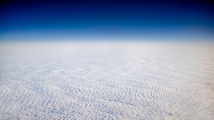 Wonderful view of cloudscape with clear blue sky from above.