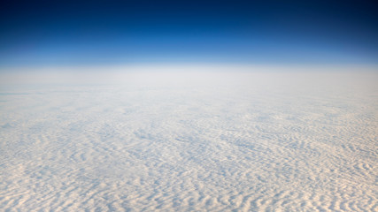 Fototapeta na wymiar The beautiful cloudscape with clear blue sky. A view from airplane window.