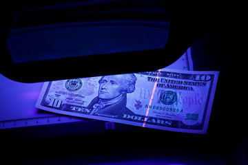 ten dollars on the photo. US banknotes. Equipment for in-depth inspection of money. Checking bills...