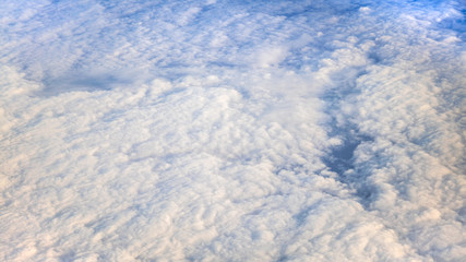 The beautiful cloudscape with clear blue sky. A view from airplane window.