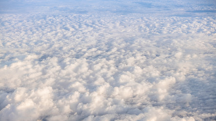 Naklejka premium The beautiful cloudscape with clear blue sky. A view from airplane window.