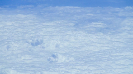 The beautiful cloudscape with clear blue sky. A view from airplane window.
