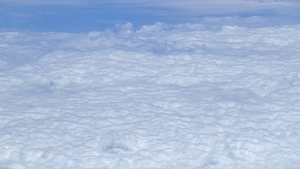 The beautiful cloudscape with clear blue sky. A view from airplane window.