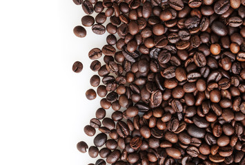 Roasted coffee beans on white background with copy space