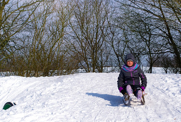 Mädchen rodelt im Schnee